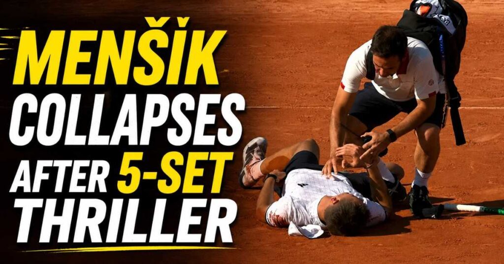 Menšík lying exhausted on the clay court after five-set Roland Garros match collapse, with medical staff attending him under intense heat conditions.