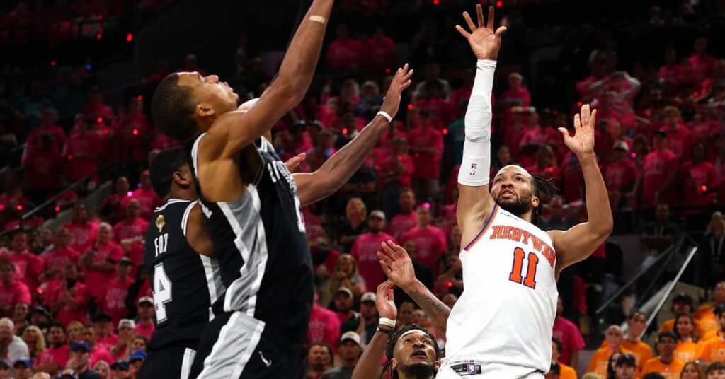 Jalen Brunson of the New York Knicks shoots a layup over defenders during the NBA Finals 2026 Game 1