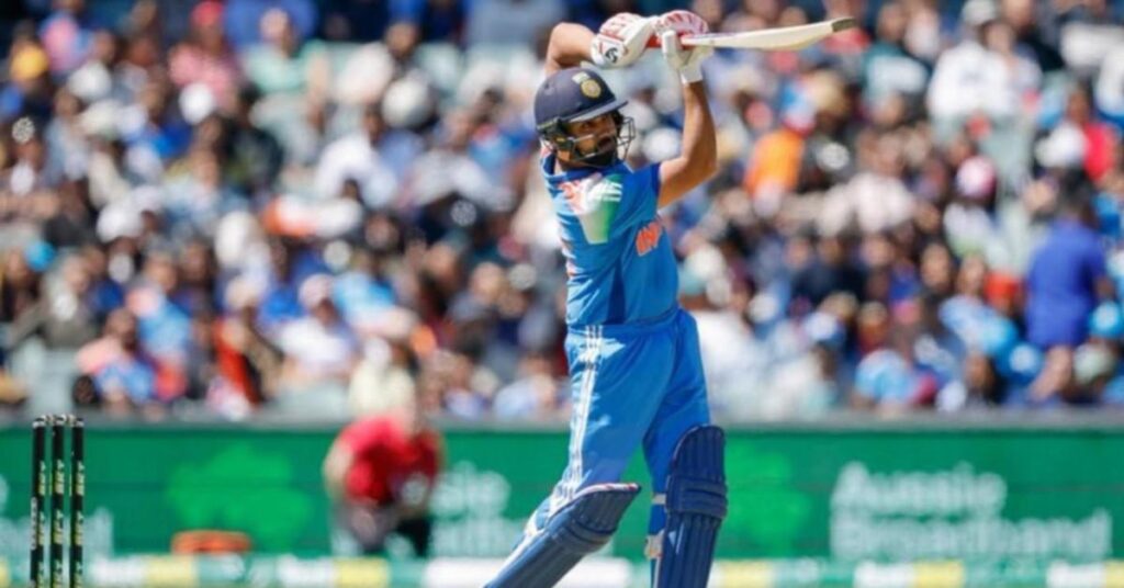 Rohit Sharma is batting with fans cheering in the background.