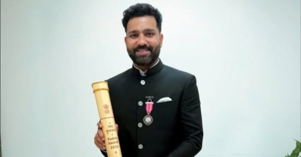 Former Indian cricket captain Rohit Sharma proudly holding his Padma Shri 2026 award scroll in black formal attire.