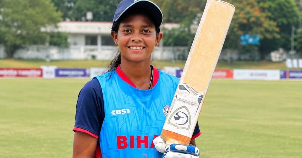 Akshara Gupta poses with her bat after scoring an unbeaten 306 runs in a Bihar Women's U-19 cricket match.
