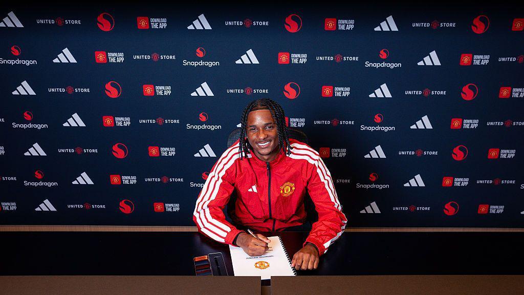Tynan Thompson signing the £8m deal with Manchester United Tynan Thompson signing the £8m deal with Manchester United